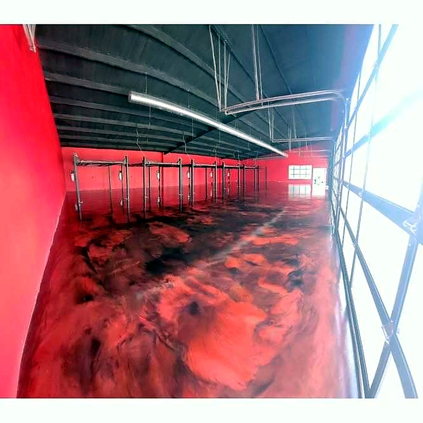 Red and black metallic epoxy floor in a warehouse