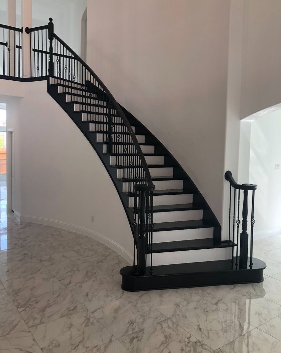 Custom curved staircase with iron balusters